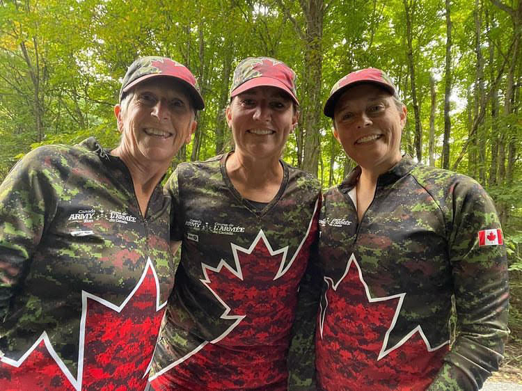 Three women wearing Canada Army Run gear smile for the camera. |