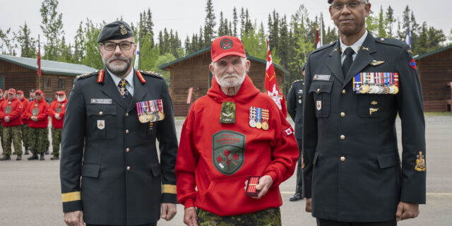 Canadian Ranger Richard Newell (center) is presented with the Canadian Forces Decoration fifth clasp by Lieutenant-General Micheal Wright, Commander Canadian Army (left), and Chief Warrant Officer Christopher Robin, the Army Sergeant Major (right).