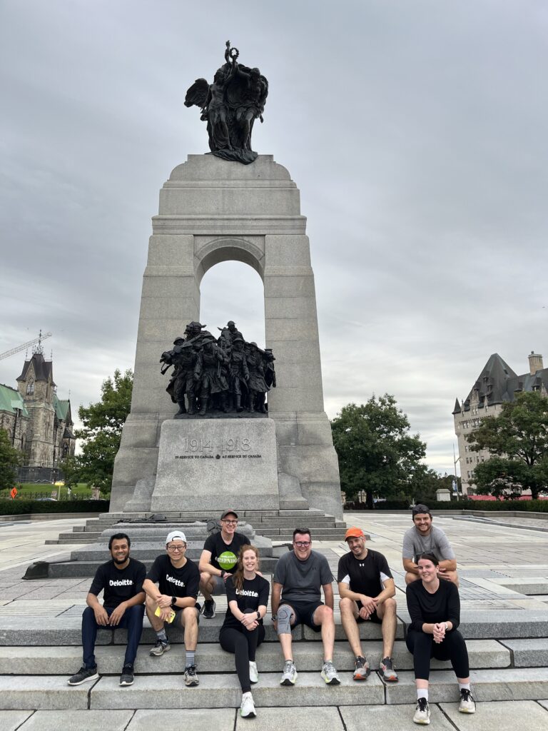 Runners pause on the steps in front of the National War Memorial in Ottawa. | Des coureurs font une pause sur les marches devant le Monument commémoratif de guerre national à Ottawa.
